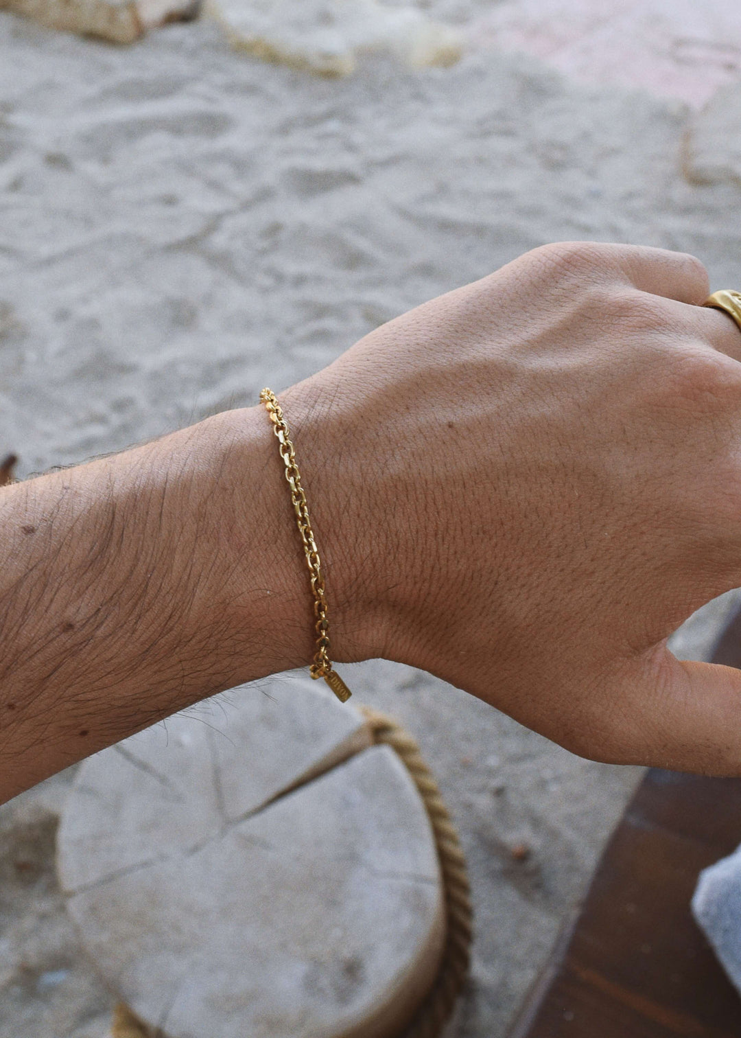 Relaxed shot of DIVON 3mm gold chain bracelet – minimal jewelry for everyday confidence