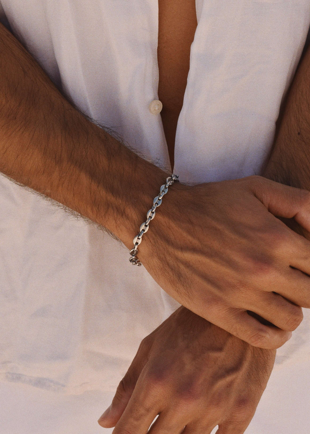 Bold 6mm silver chain bracelet by DIVON – styled with crisp white shirt, modern and durable
